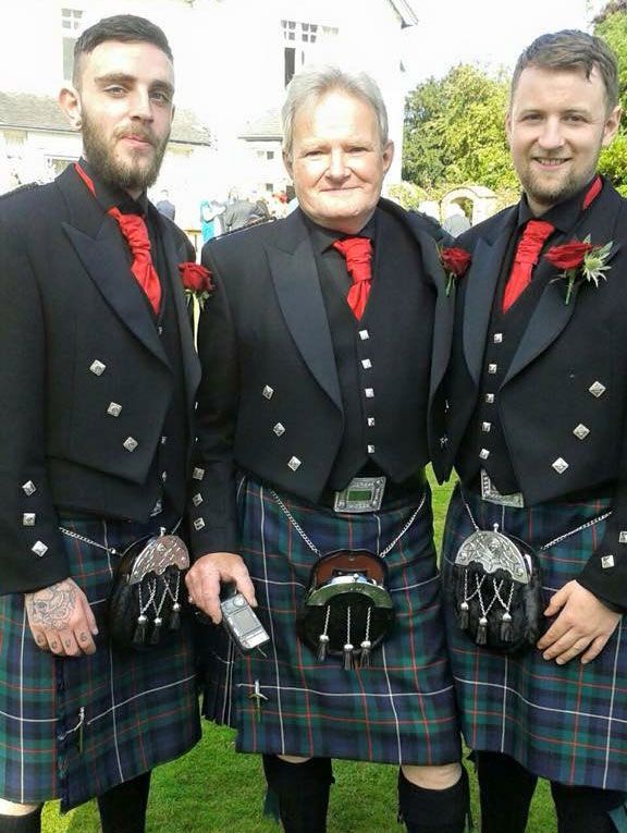 three men wearing traditional highland suits with kilts 